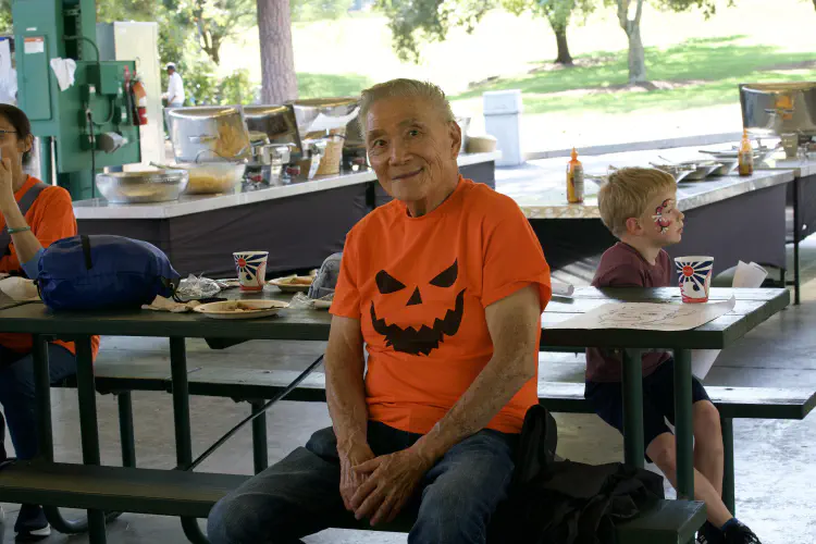 Man sitting, smiling at banquet