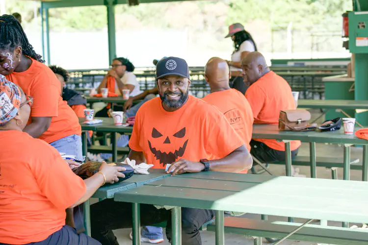 Man smiling at outdoor banquet